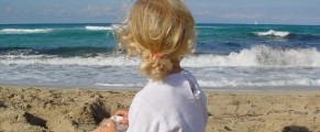 young girl sitting on beach in majorca