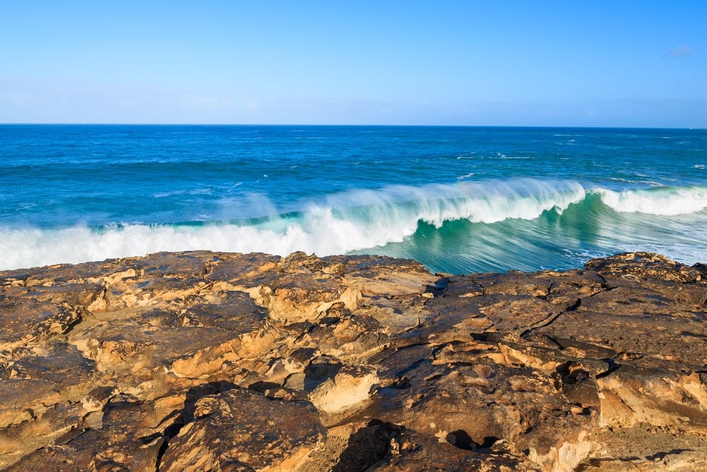 Rocks and ocean wave on La Pared beach on western coast of Fuerteventura, Canary Islands, Spain
