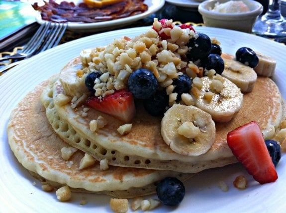 Macadamia nut pancakes with fruit is a delicious Hawaii breakfast