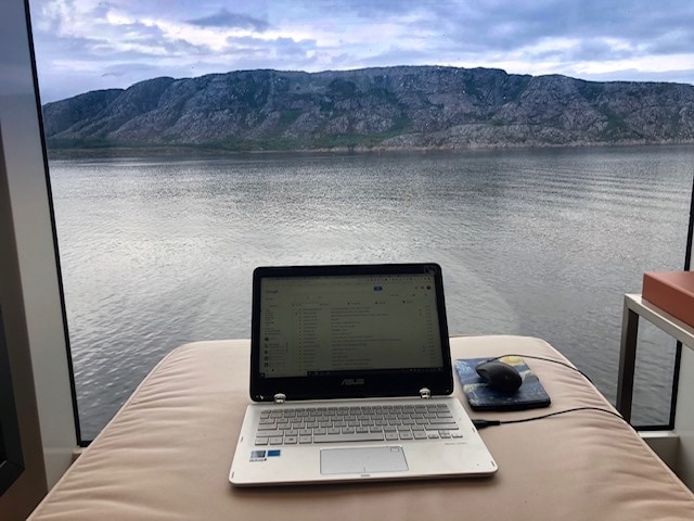 laptop looking out the window of a cruise ship