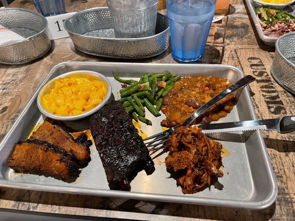 a plate of barbecue meat and sides