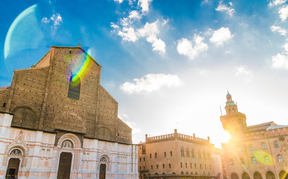 Basilica di San Petronio church facade and Palazzo d'Accursio (Palazzo Comunale) palace building on Piazza Maggiore square in old historical city center of Bologna, Emilia-Romagna, Italy