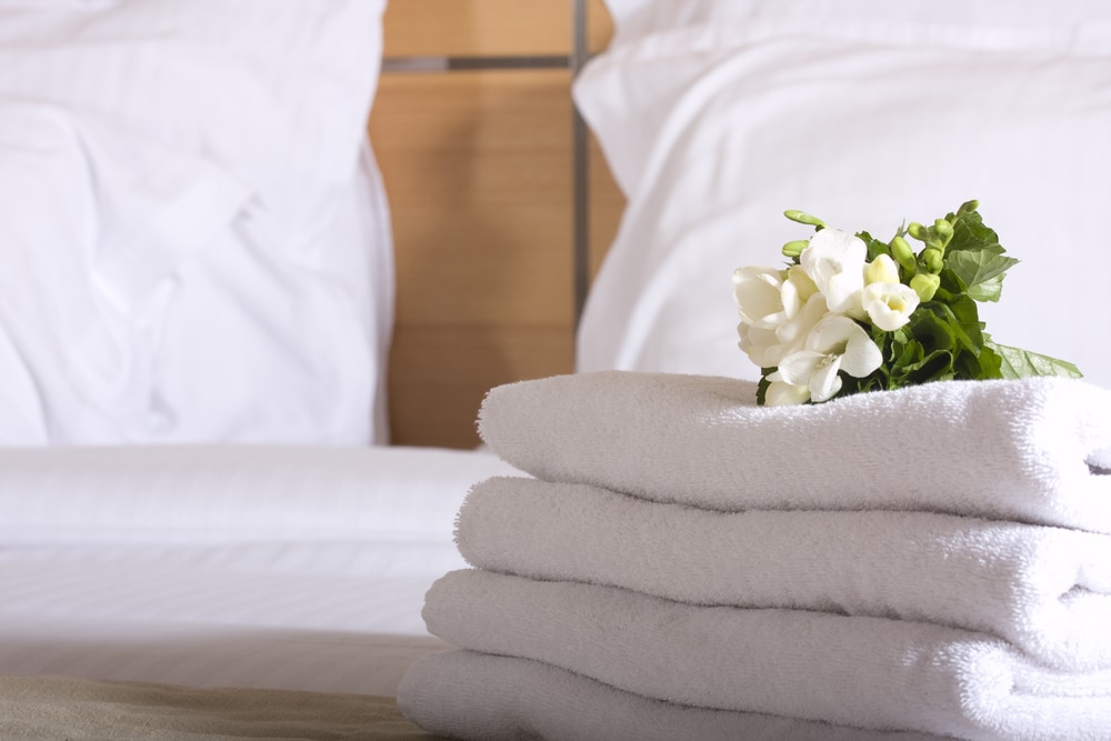 white towels on a white bed at a luxury hotel