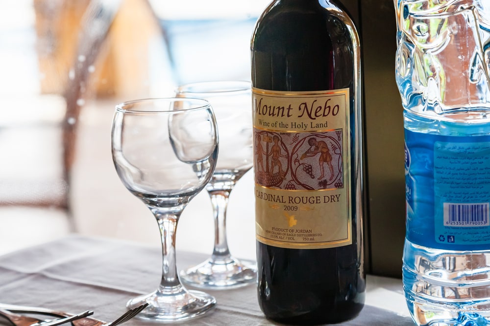 Bottle of Jordanian wine Mount Nebo (Wine of the Holy Land) with two wine glasses