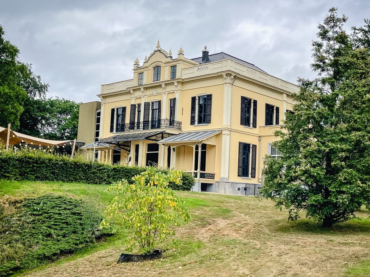 a yellow mansion with stately grounds that houses the Arnhem Museum in the Netherlands