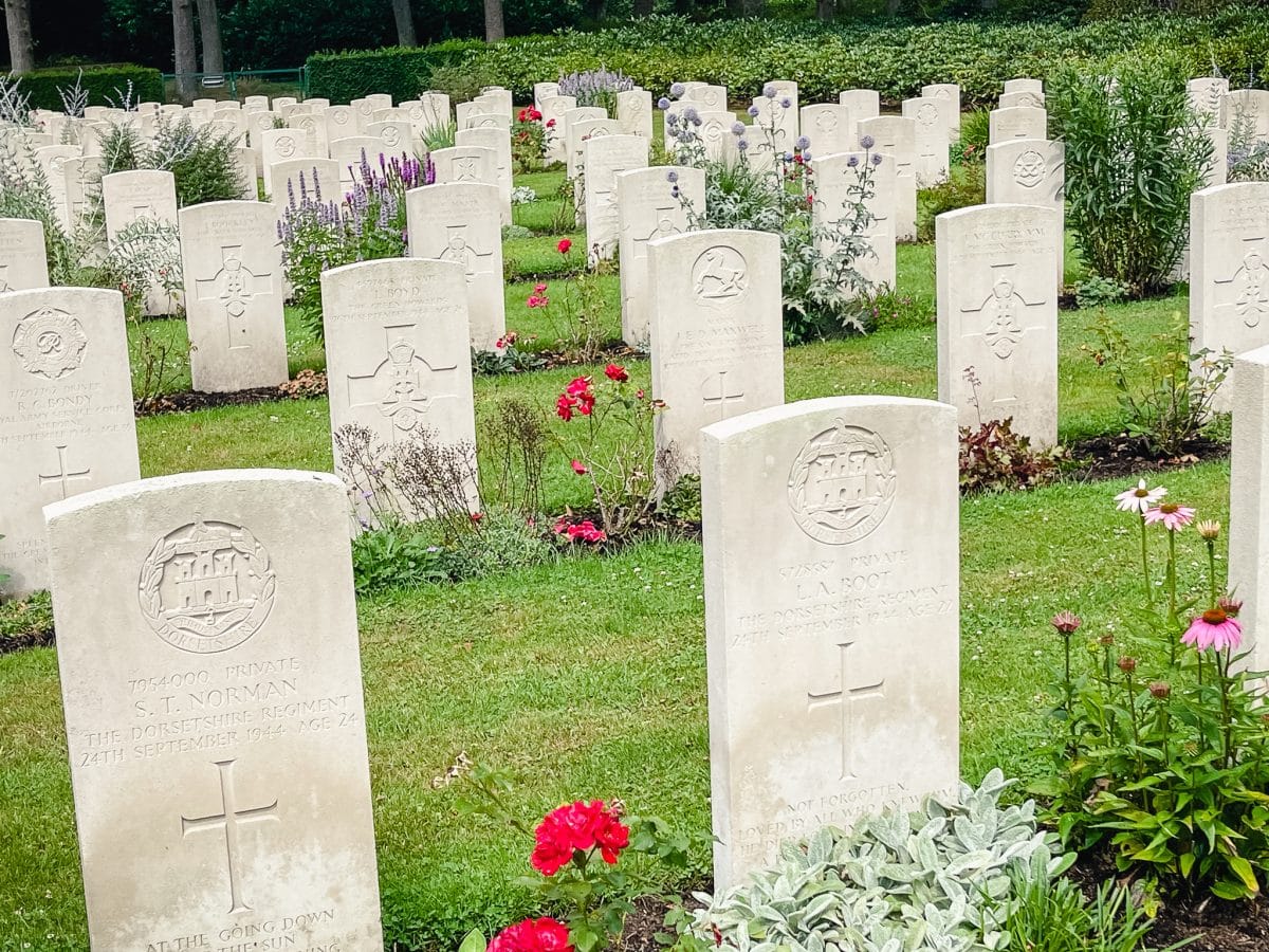 rows of white headstones marking military graves at Arnhem Oosterbeek War Cemetery in the Netherlands
