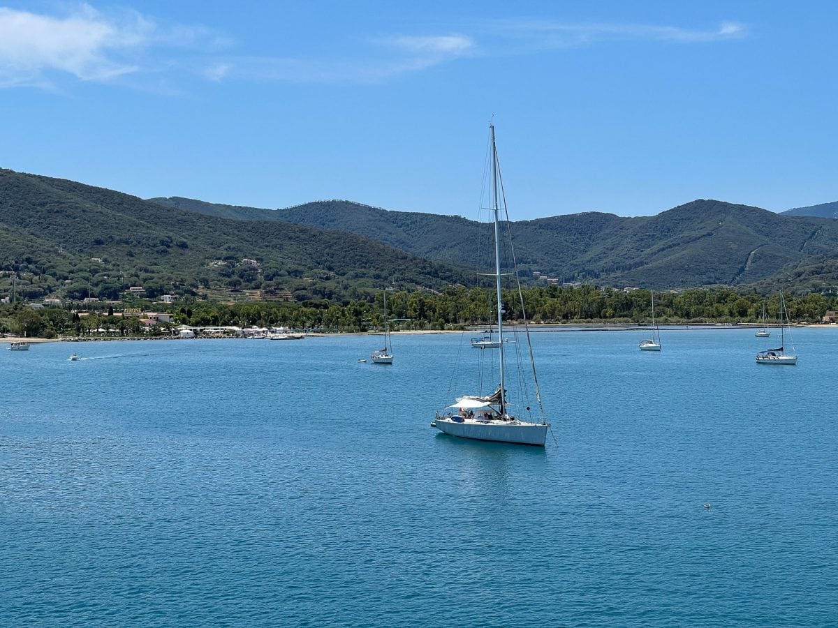 sailboats on crystal clear blue water on the island of elba in italy