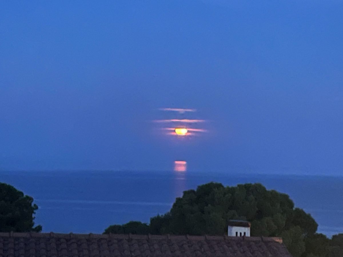 a sunset over the water on the island of elba in tuscany italy