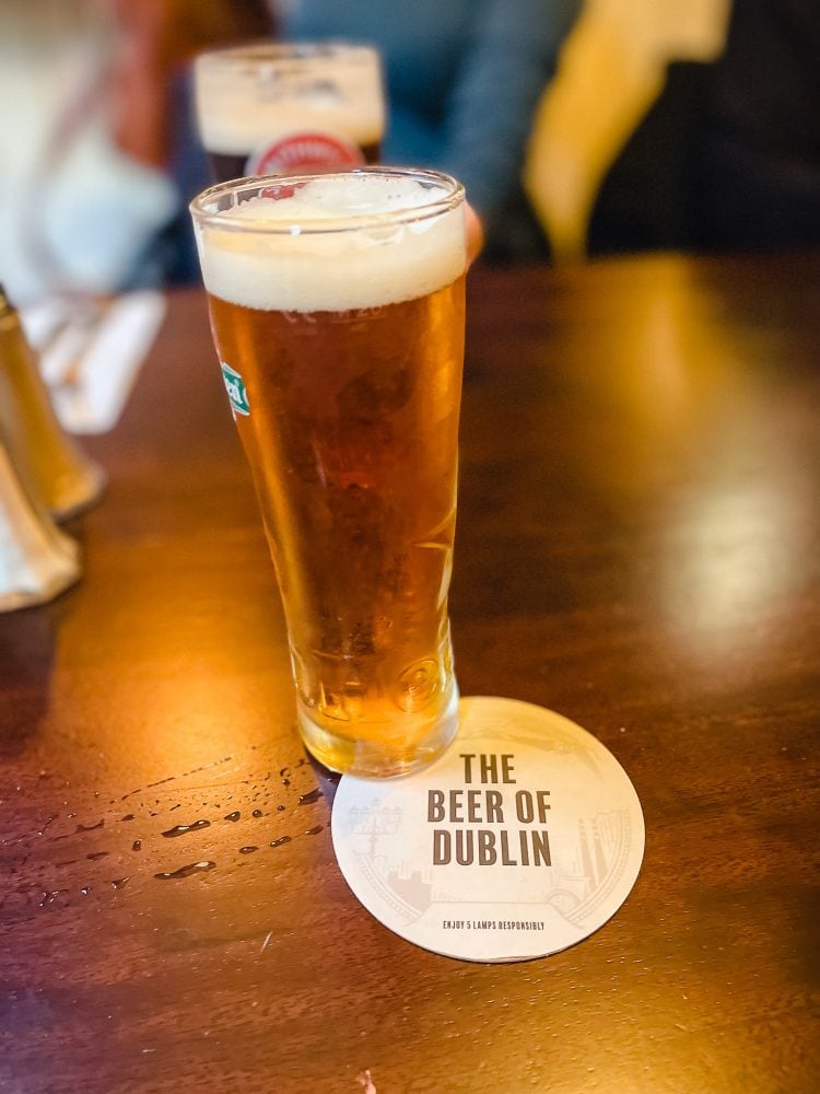 a half pint of beer on a coaster in an literary dublin pub