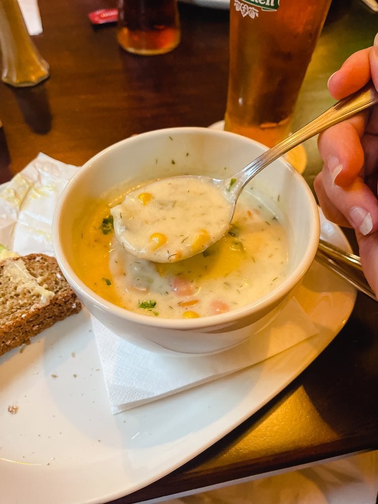 bowl of clam chowder with spoon dipping into it