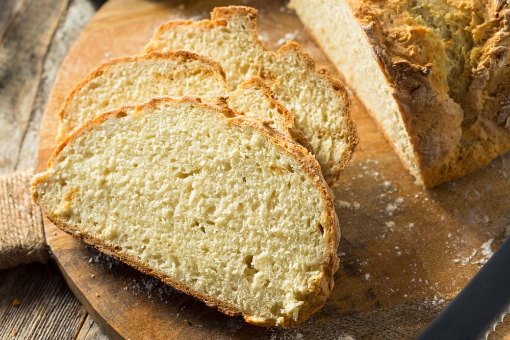 slices of homemade irish soda bread on a bread plank