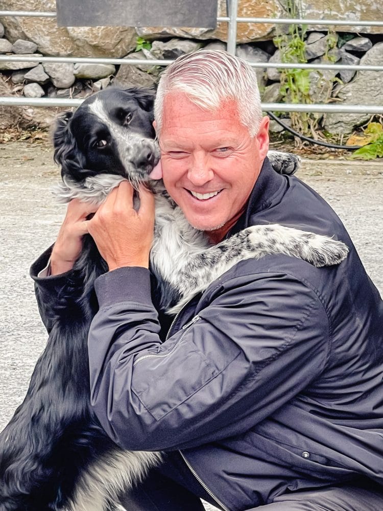 a man embracing a dog