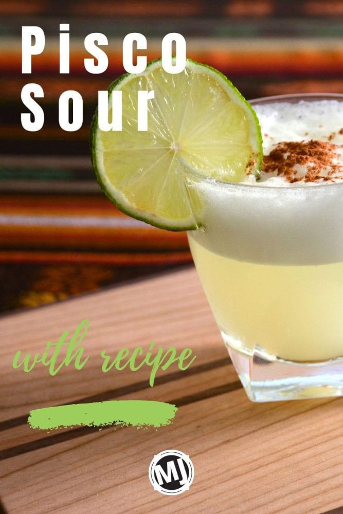 a pisco sour with a lime wheel garnish