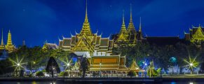 16 Incredible Things to Do in Bangkok, Thailand 4 Grand Palace at night in Bangkok, Thailand, illuminated historic Thai architecture with reflections in water.