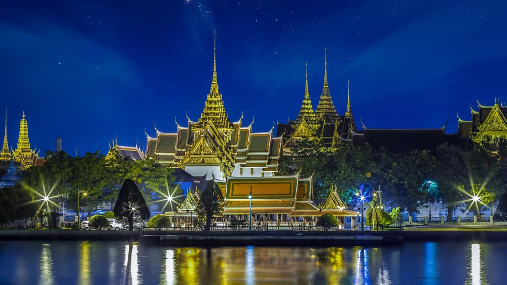 grand palace in bangkok as seen at night from the river