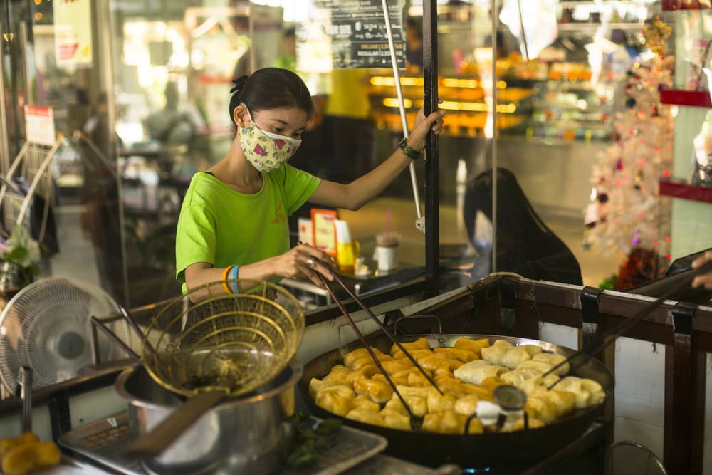 street vendor selling food a bangkok market