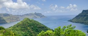 Things to Do in the Marquesas Islands 13 Lush green island landscape with ocean views and blue sky in Hawaii.