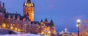 Vintage Château Frontenac in Quebec City at dusk, snowy winter scene, travel destination in Canada.