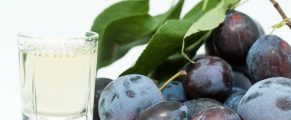 Tuica: Traditional Romanian Brandy (with recipes) 5 Plums and a glass of wine.