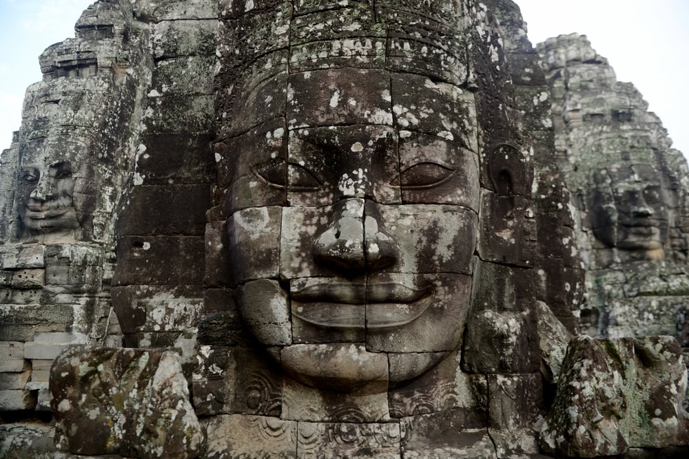 Stone face at the Bayon Temple the Tempel Ruins of Angkor Thom in the Temple City of Angkor near the City of Siem Reap in the west of Cambodia. Cambodia, Siem Reap, April 2014