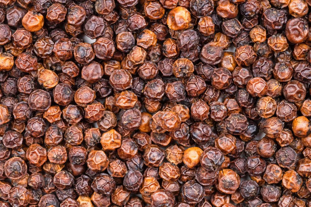 A close up of a bunch of dried black pepper, cambodia kampot pepper