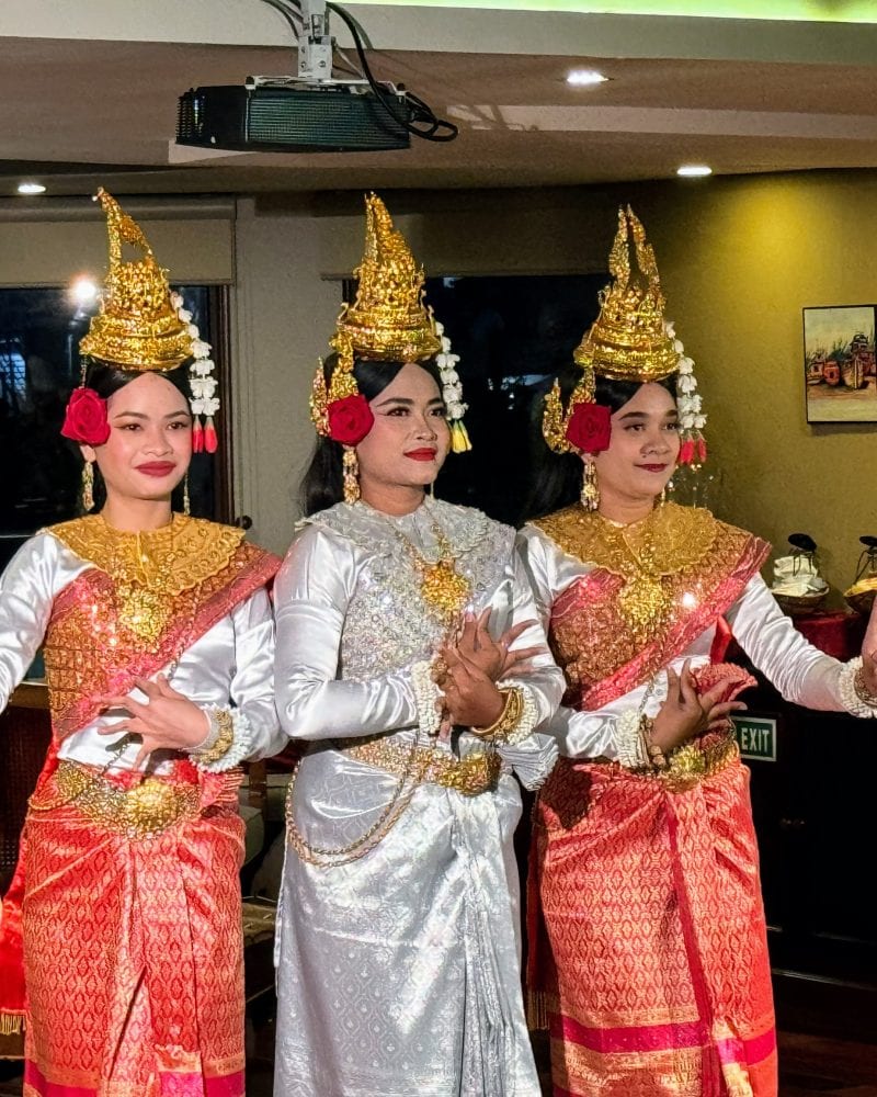 Three women in traditional Cambodia sampot dancing.