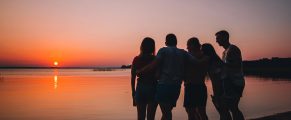 Friendcation: 12 Fun Destinations & Tips for a Vacation with Friends 3 Silhouetted friends enjoying sunset by the river at Traveling with MJ.