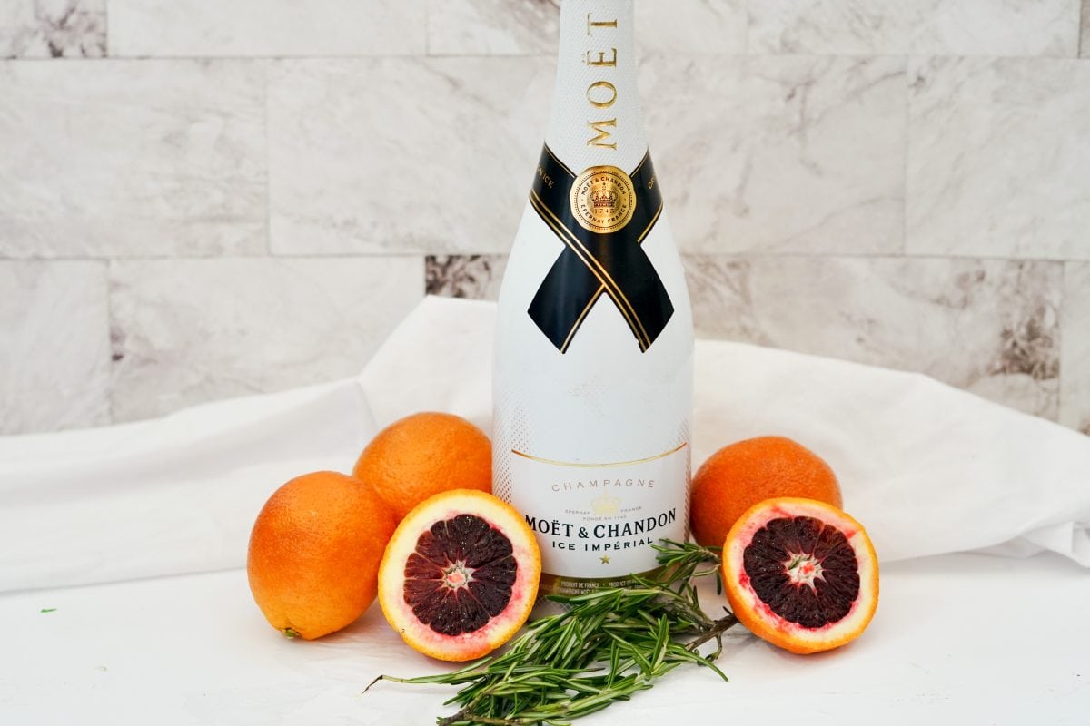 Blood Orange Mimosas: A Refreshing Twist on a Classic 5 All the ingredients for a blood orange mimosa: blood oranges, champagne, rosemary.
