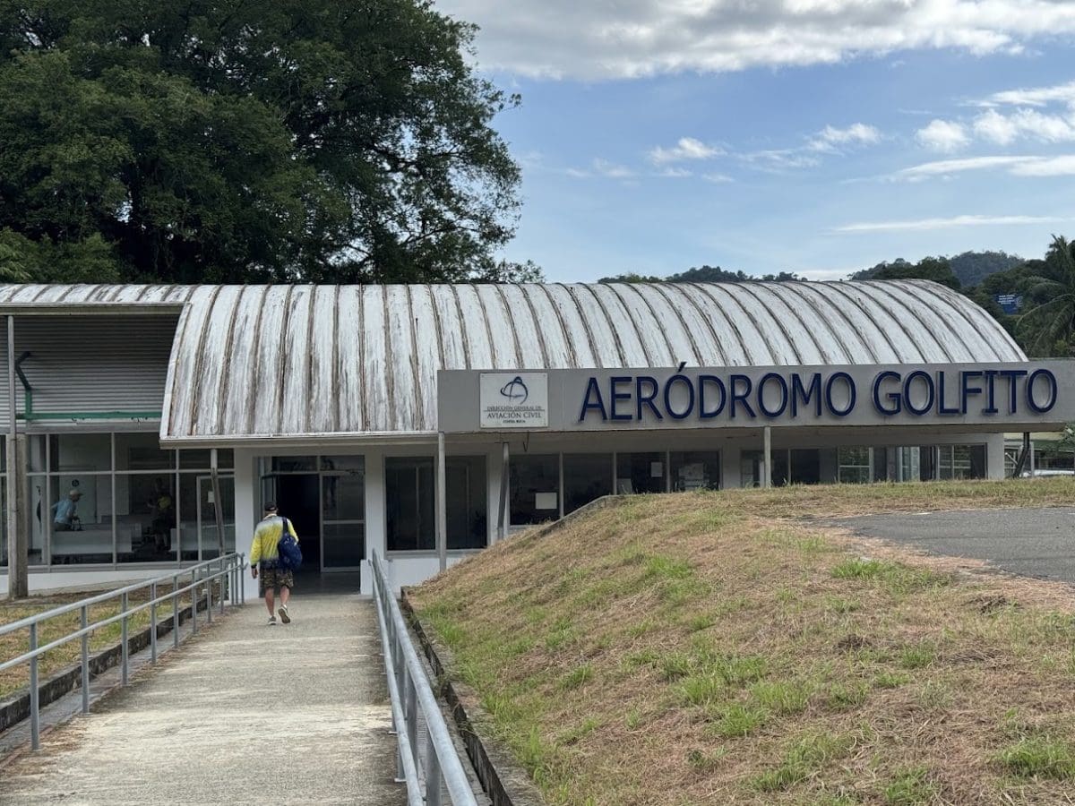 Adventure Cruising with Kontiki Expeditions in Costa Rica 35 Visitor walking towards Aerodromo Golfto in Costa Rica with lush greenery.