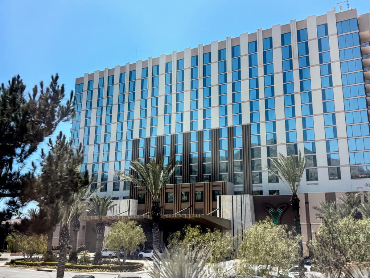 Exterior view of Yaamava' Resort & Casino with modern architecture and palm trees.