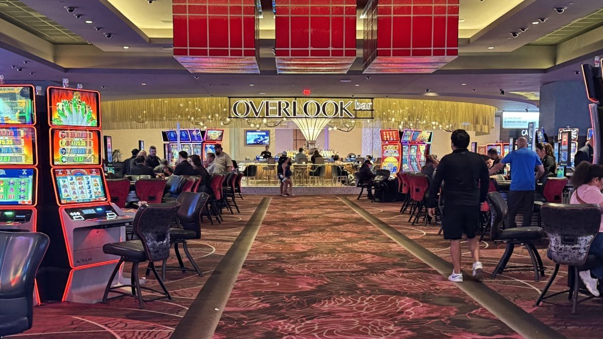 Casino gaming area at Overlook Casino with slot machines and players.