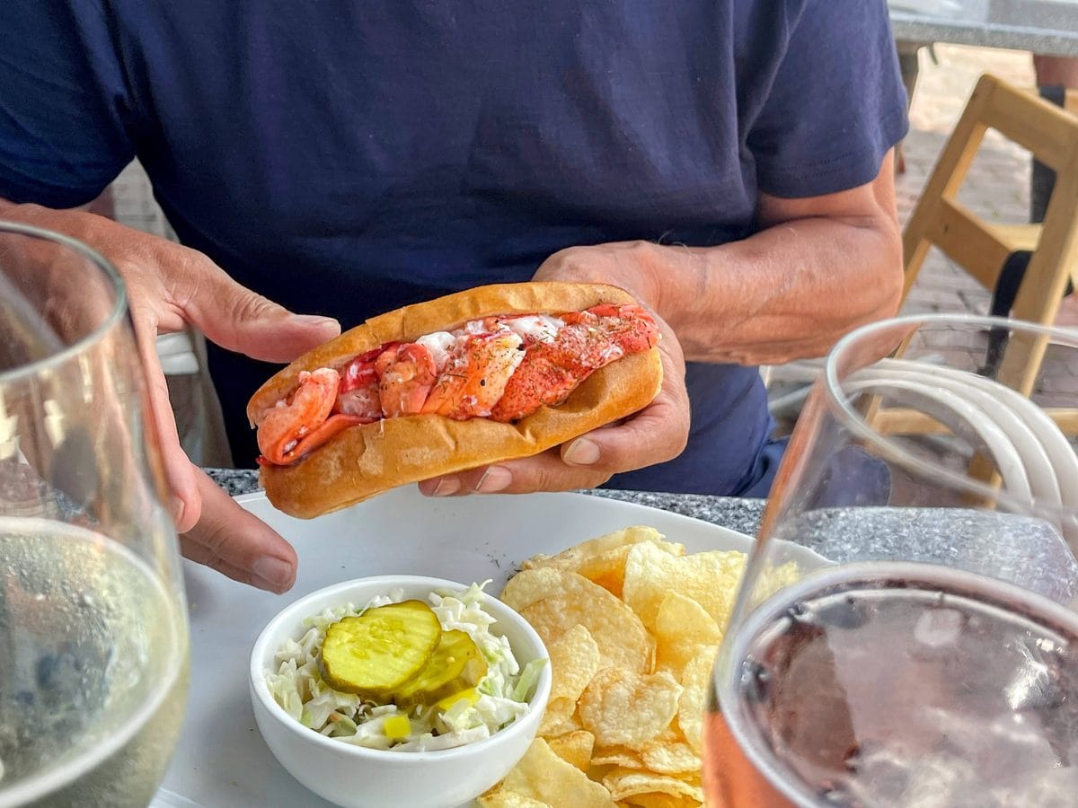 Visit L.L.Bean in Freeport, Maine: More Than a Shopping Stop 5 Lobster roll with potato chips and pickle on a table.