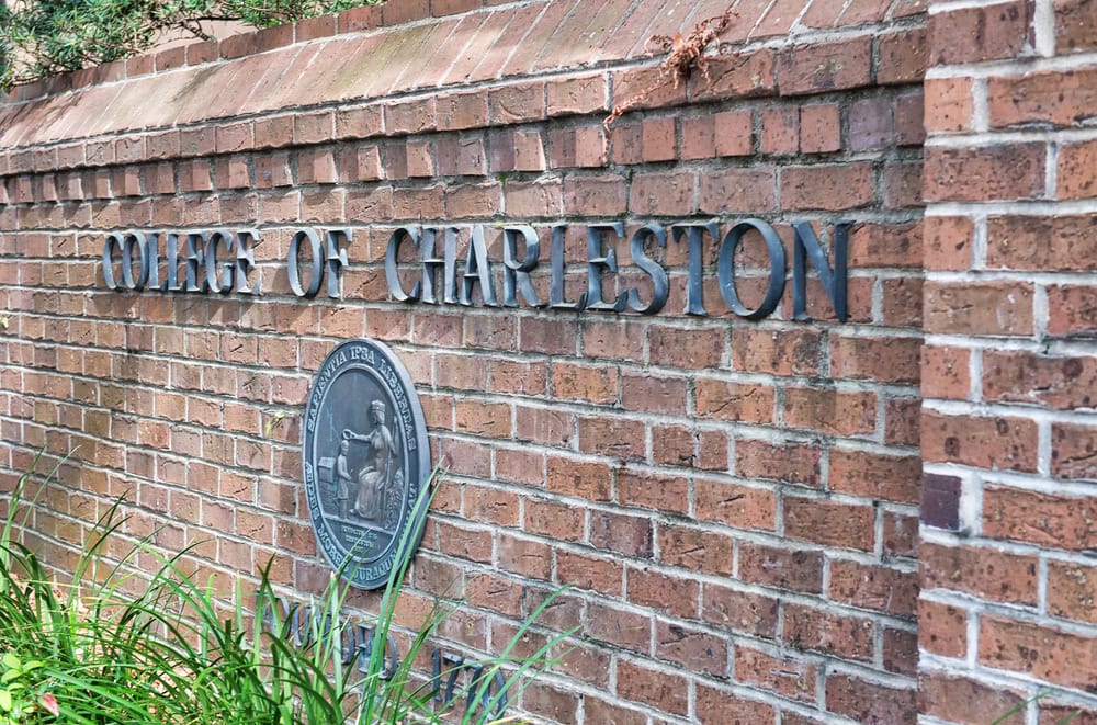 12 Terrific Museums in Charleston to Put on Your To-Visit List 8 Brick sign reading College of Charleston with a circular seal on the wall.